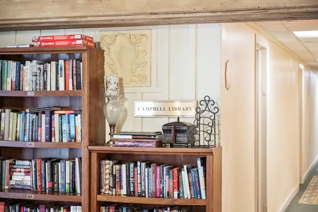 a living room with fireplace furniture and a chandelier