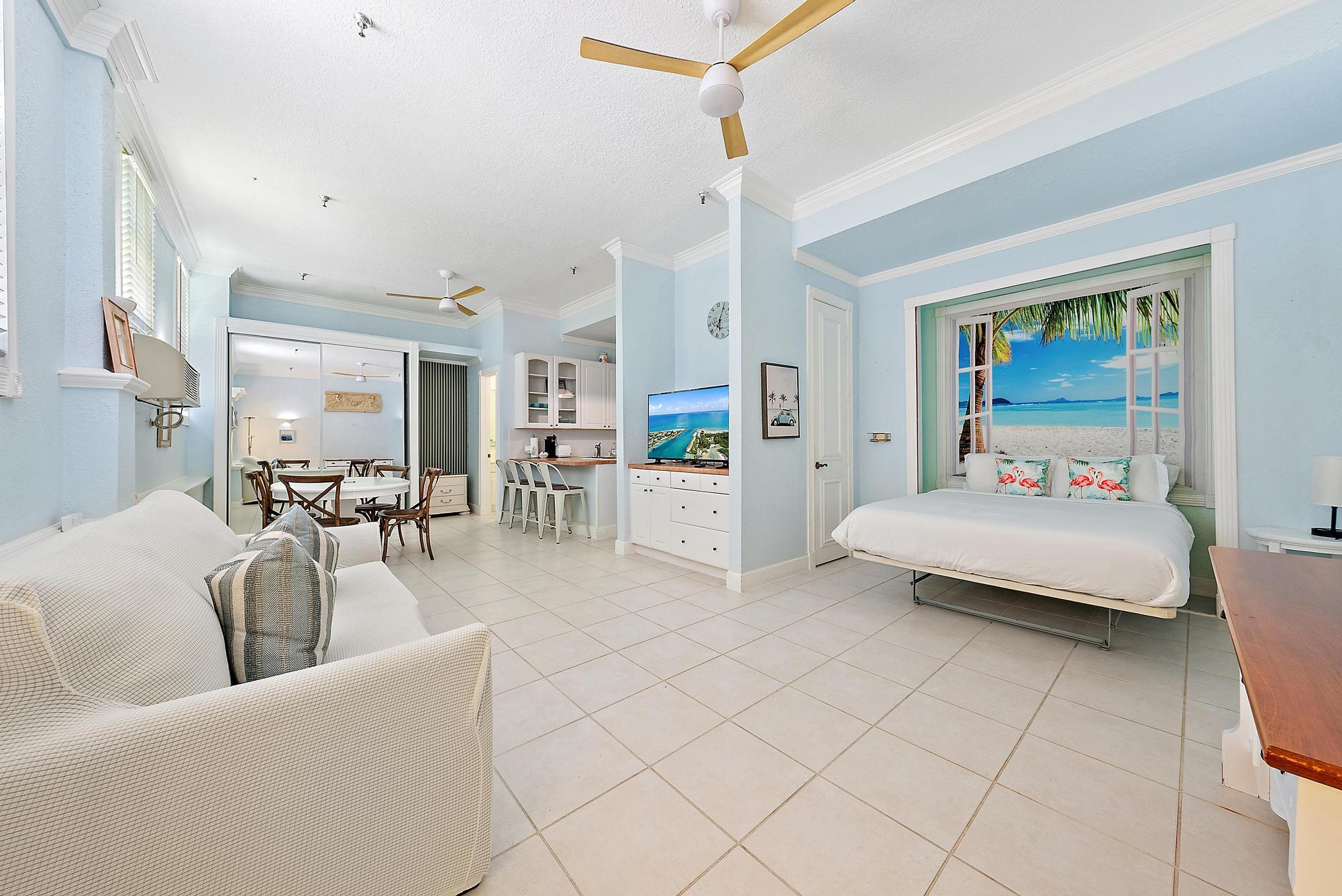 235 Sunrise Avenue, Unit 1050 Palm Beach, FL 33480 - Photo 3 of 29 a living room with furniture and a flat screen tv