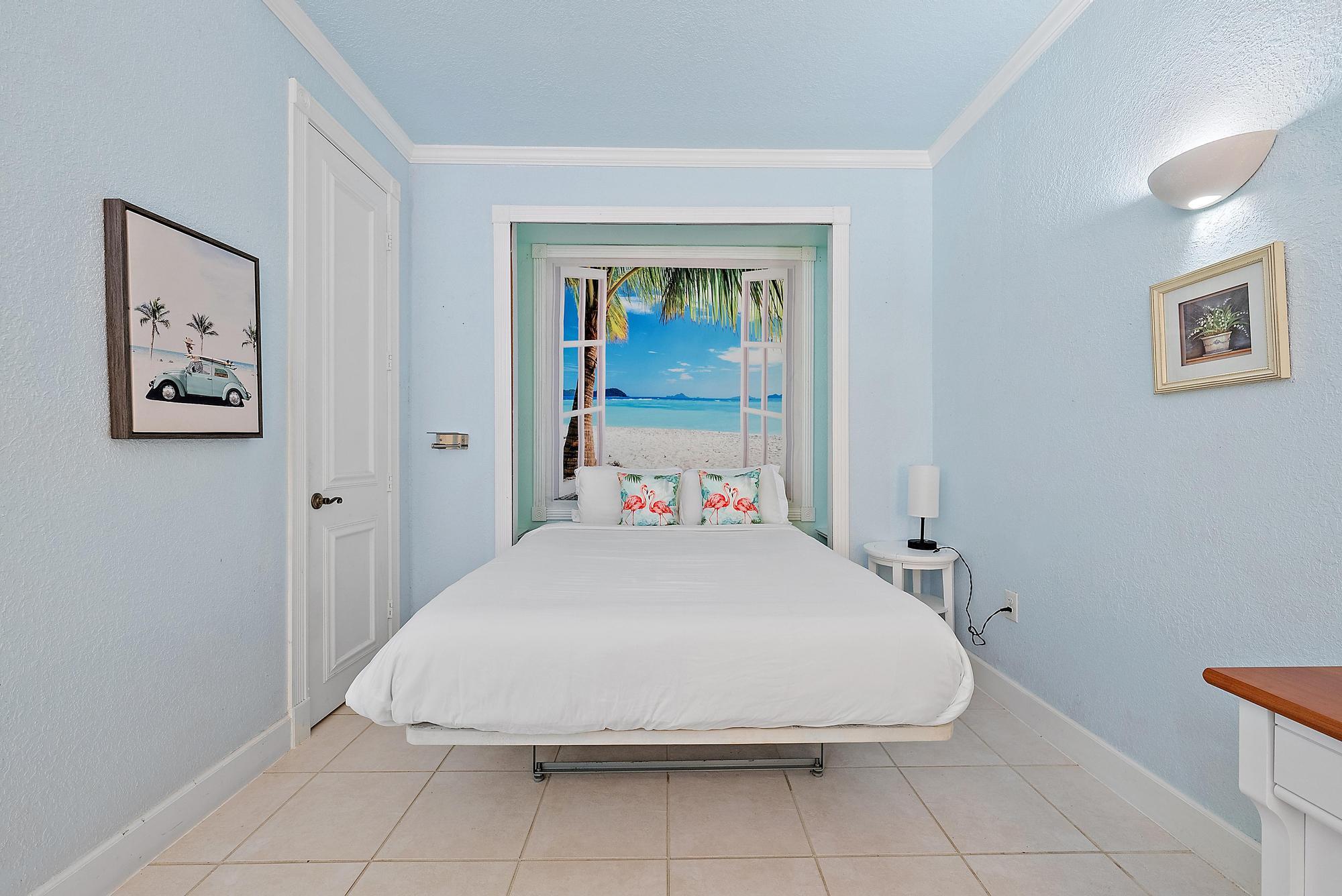 235 Sunrise Avenue, Unit 1050 Palm Beach, FL 33480 - Photo 4 of 29 a large bed sitting in a bedroom next to a window