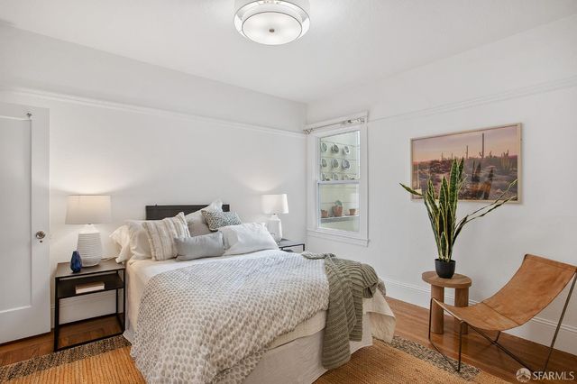 a bedroom with a bed and chair