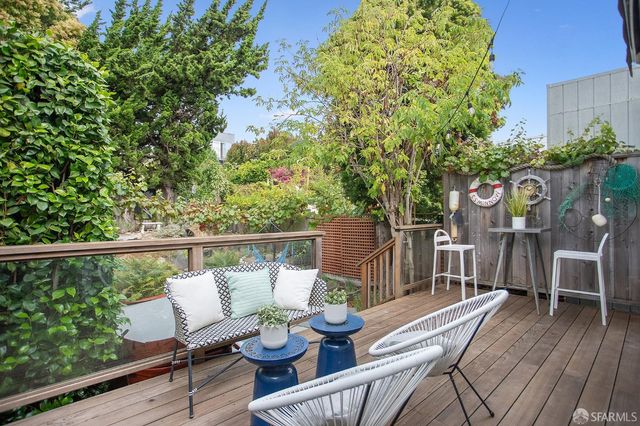 a view of balcony with furniture and wooden deck