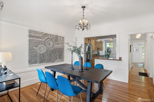 a view of a dining room with furniture wooden floor and a chandelier