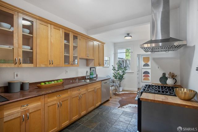 a kitchen with stainless steel appliances granite countertop a sink and cabinets