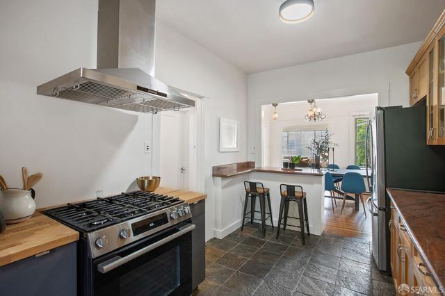 a kitchen with a stove and white cabinets