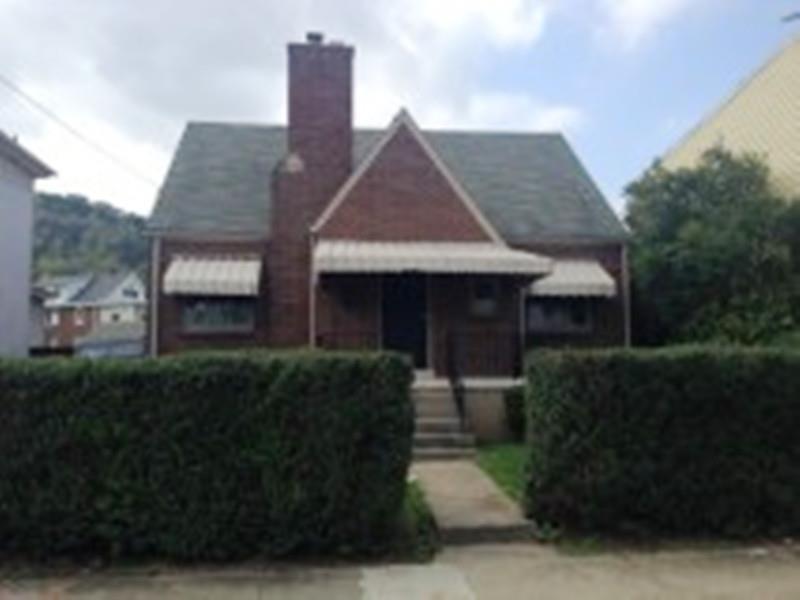 Exterior Front with hedges for complete privacy.