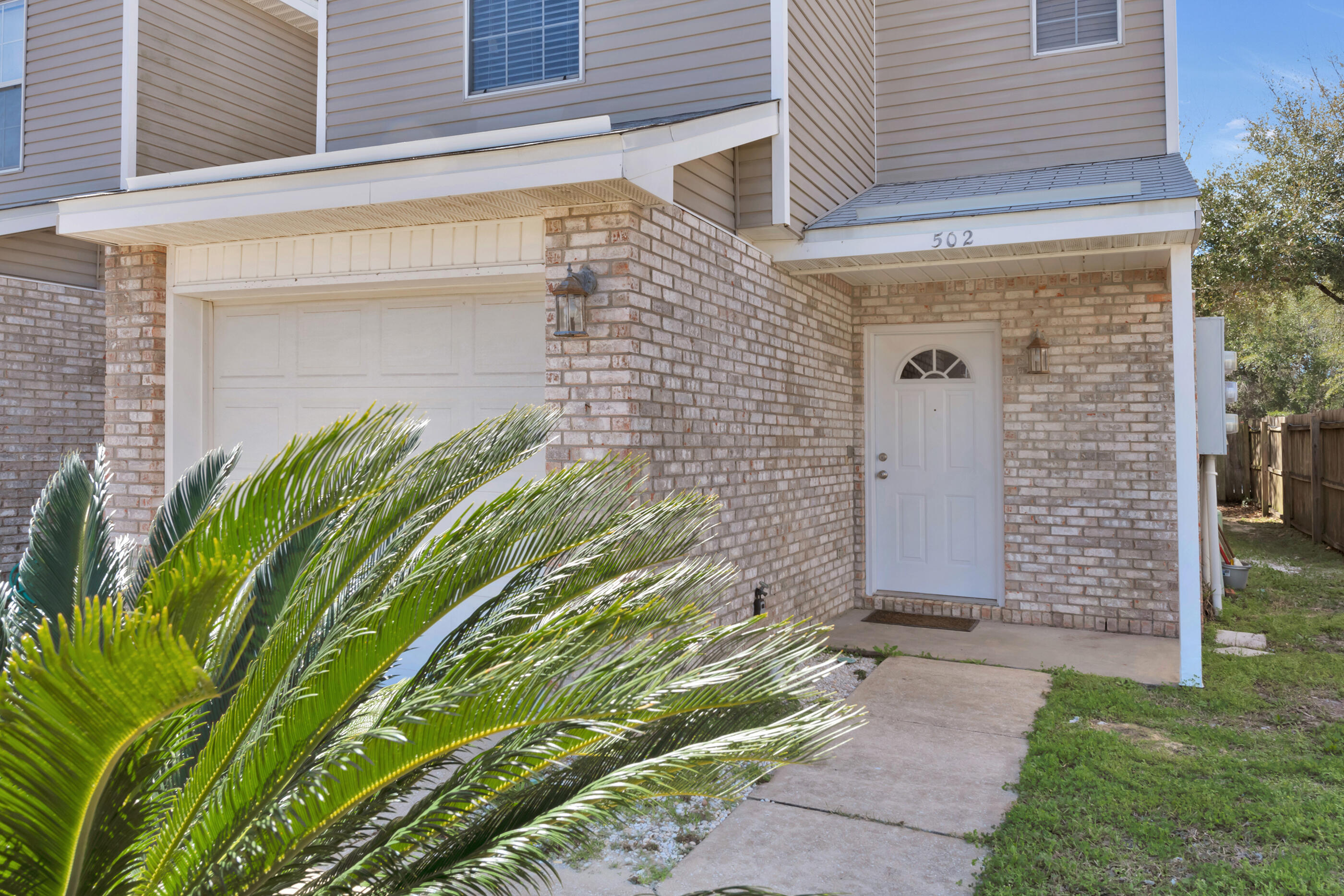 502 Keystone Road Mary Esther, FL 32569 - Photo 1 of 16 a front view of a house with a garden