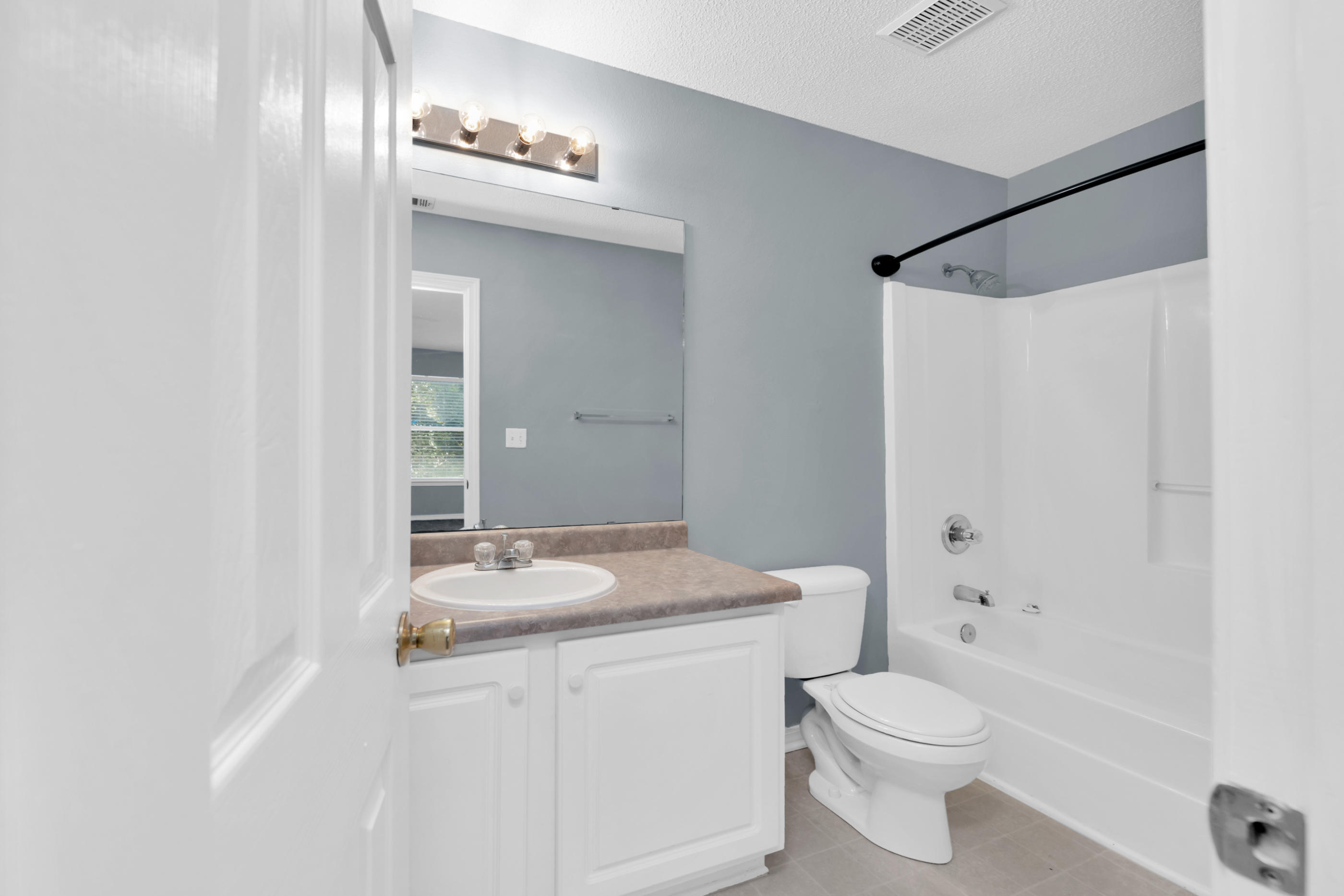 502 Keystone Road Mary Esther, FL 32569 - Photo 12 of 16 a bathroom with a granite countertop sink a toilet and shower