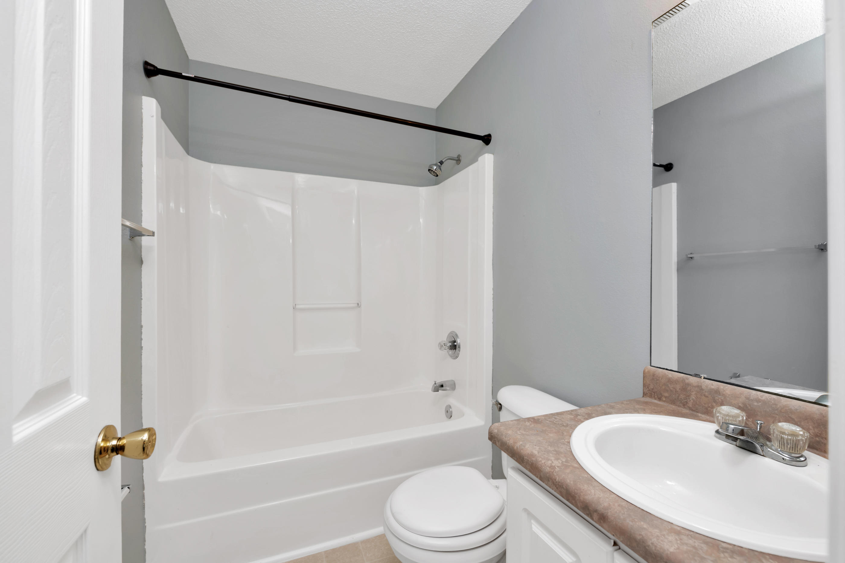 502 Keystone Road Mary Esther, FL 32569 - Photo 15 of 16 a bathroom with a granite countertop bathtub shower sink vanity mirror and toilet