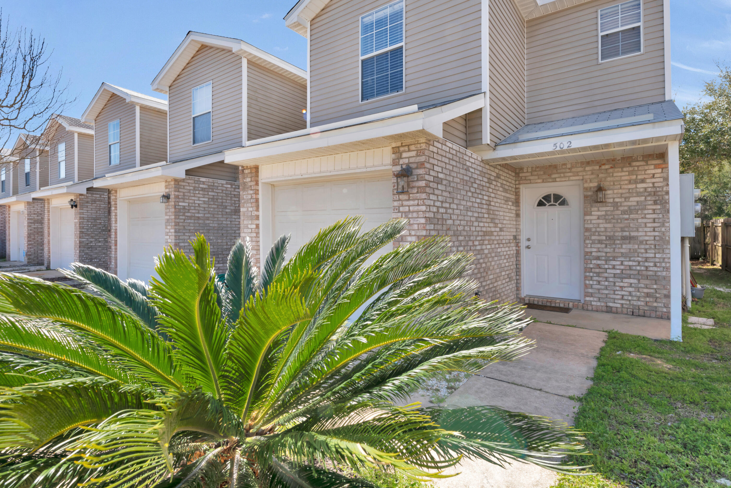502 Keystone Road Mary Esther, FL 32569 - Photo 2 of 16 a front view of a house with a garden