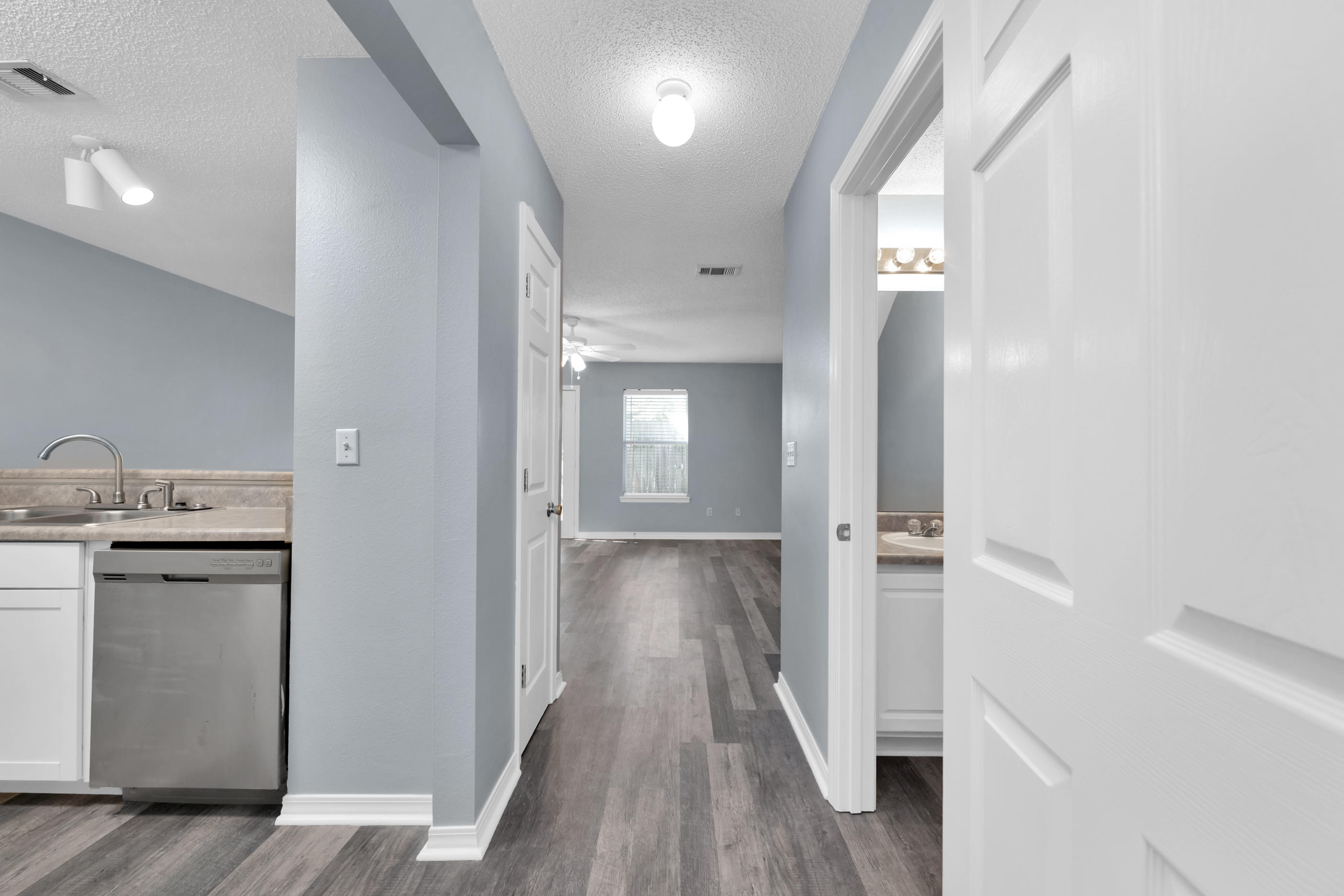502 Keystone Road Mary Esther, FL 32569 - Photo 4 of 16 a view of a hallway with wooden floor and closet