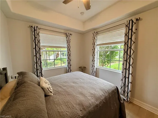 a bed sitting in a room next to a window