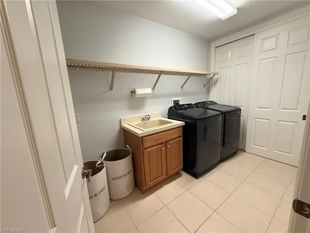 a view of a swimming pool with lawn chairs and plants