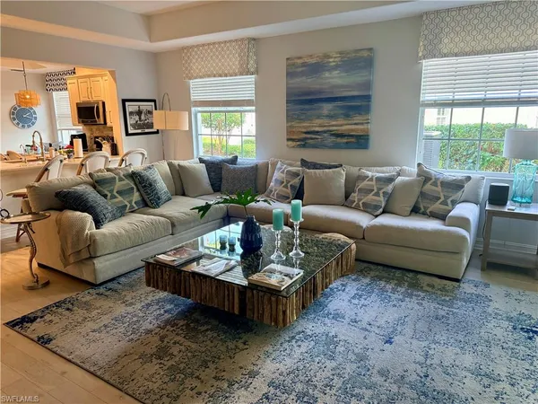 a living room with furniture couches and a large window