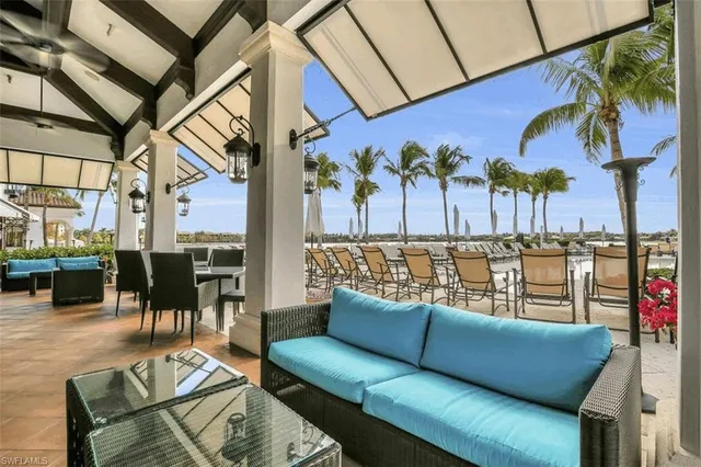 a swimming pool with outdoor seating and city view