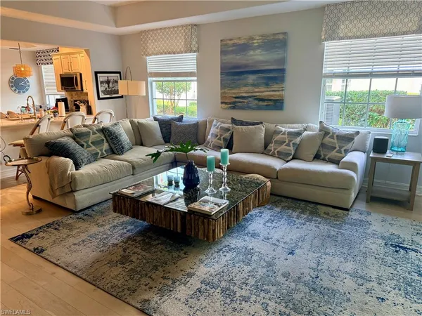 a living room with furniture and a large window