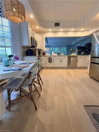 a kitchen with stainless steel appliances kitchen island granite countertop a sink and cabinets