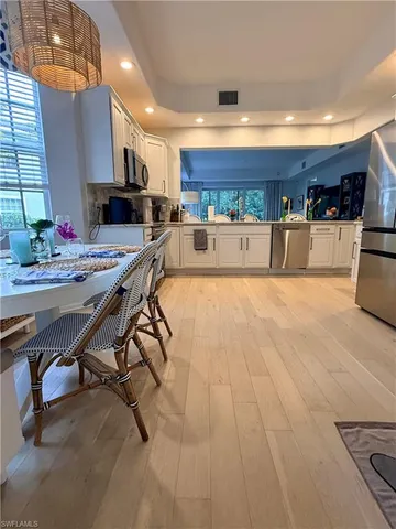 a kitchen with stainless steel appliances kitchen island granite countertop a sink and cabinets
