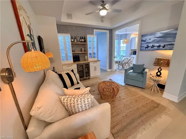 a living room with furniture and a floor to ceiling window