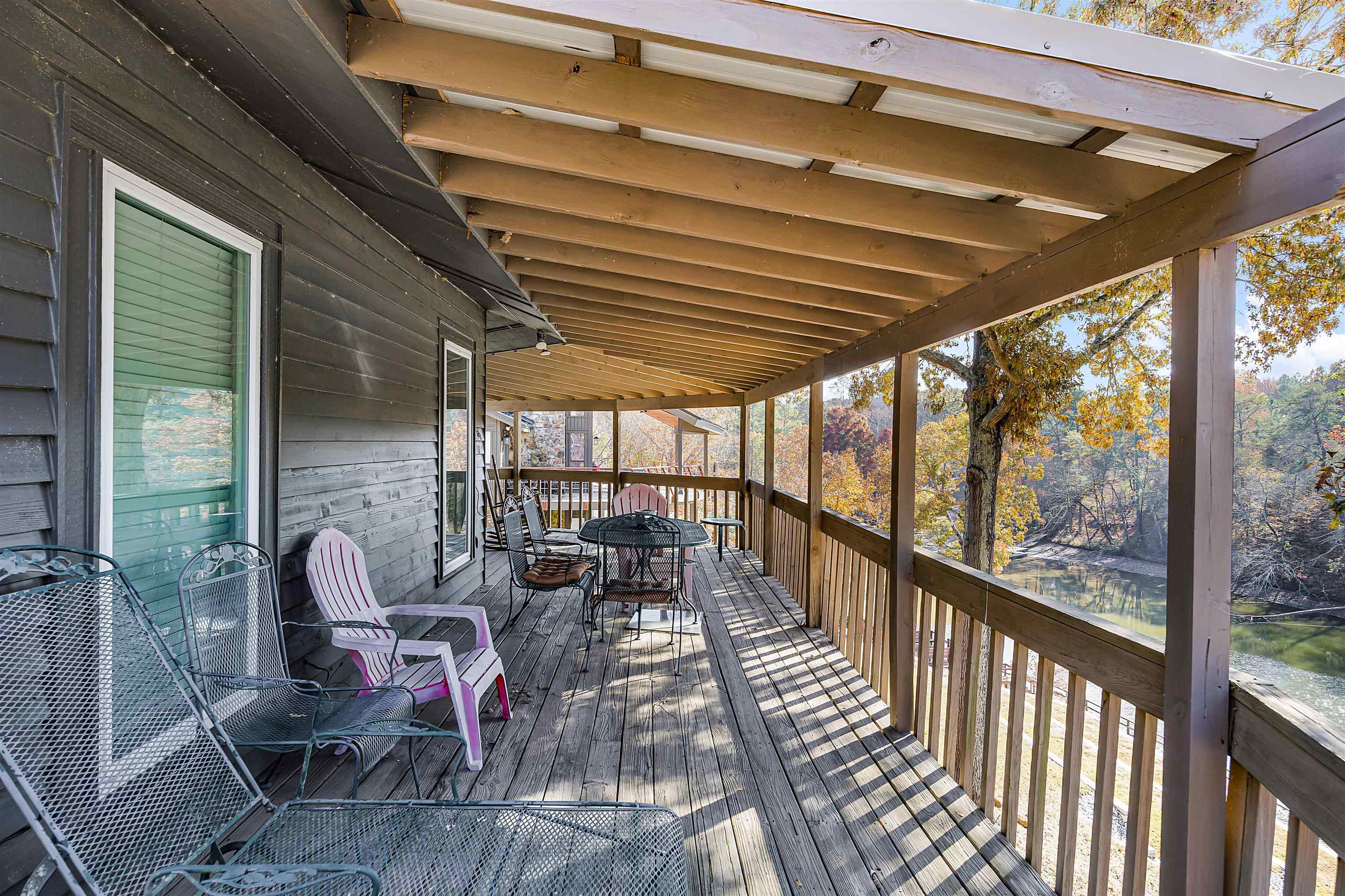 80 Riviera Cove Cherokee, AL 35616 - Photo 26 of 31 Wooden terrace featuring outdoor dining area and view of scattered trees