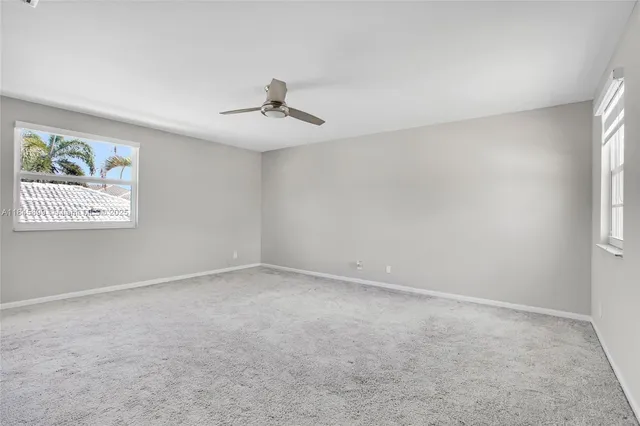 a view of room with a ceiling fan and window