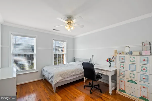 a bedroom with a bed and a desk in it