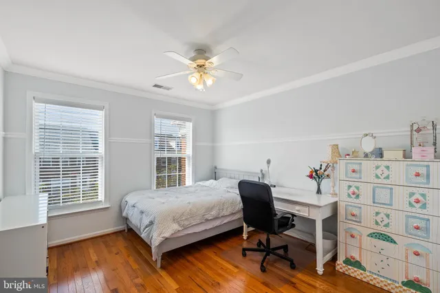 a bedroom with a bed and a desk in it