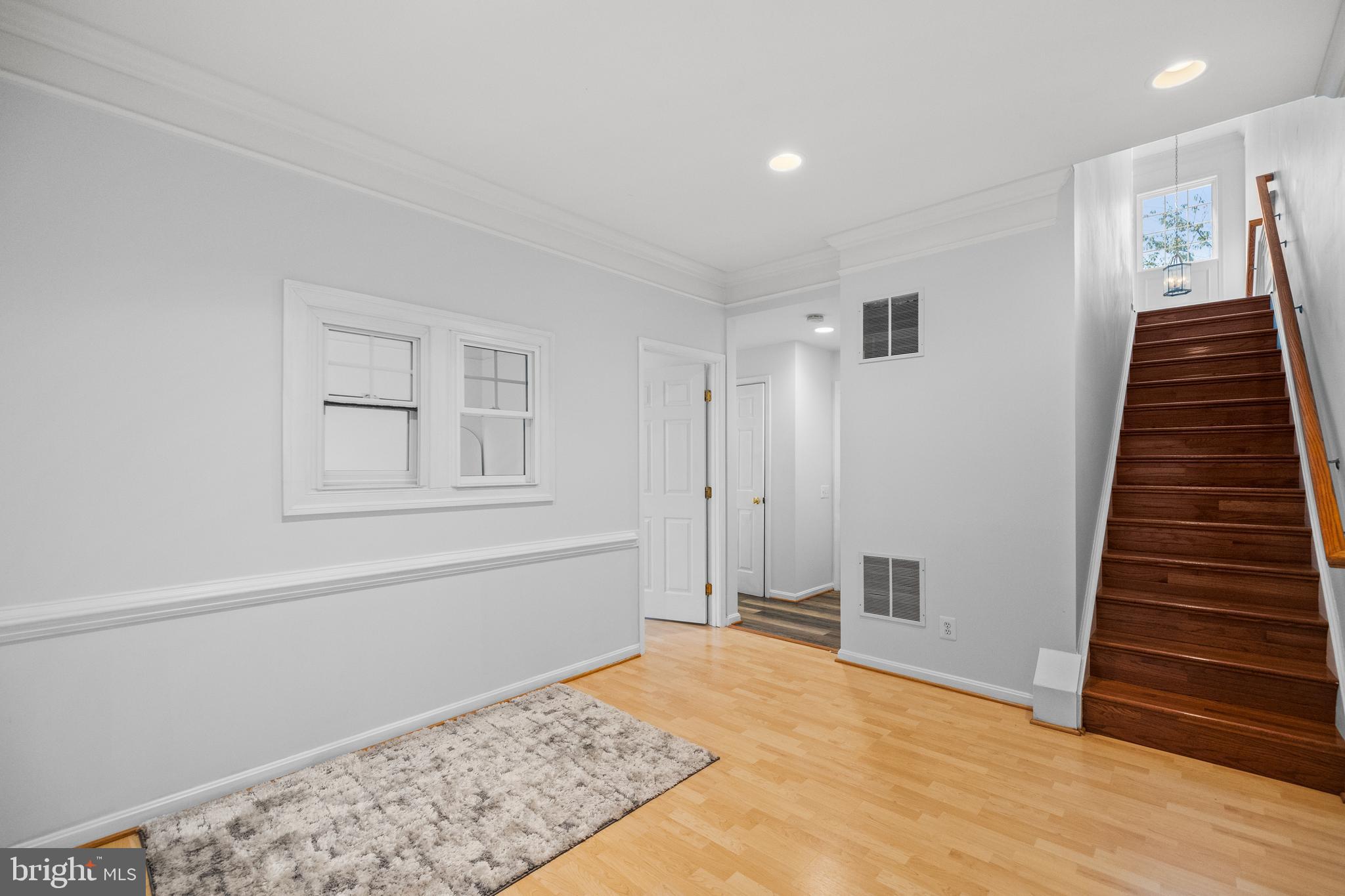 15016 Danube Way Haymarket, VA 20169 - Photo 16 of 22 a view of a livingroom with wooden floor and stairs