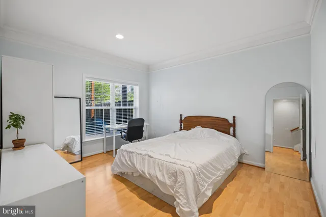 a spacious bedroom with a bed and glass door