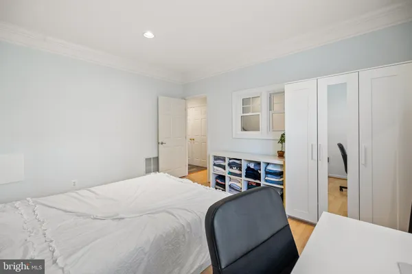a bedroom with furniture and a painting