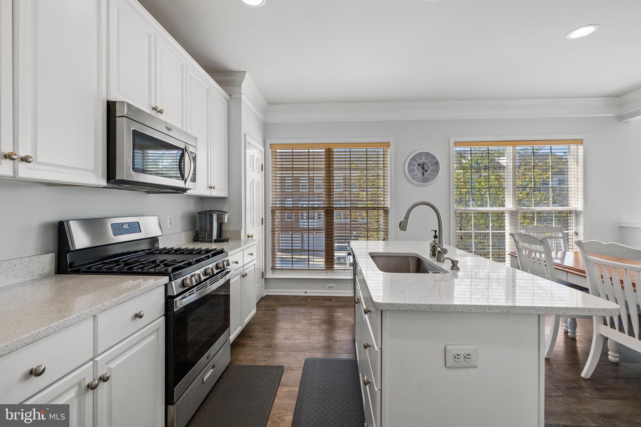 15016 Danube Way Haymarket, VA 20169 - Photo 7 of 22 a kitchen with stainless steel appliances a stove a sink and a microwave
