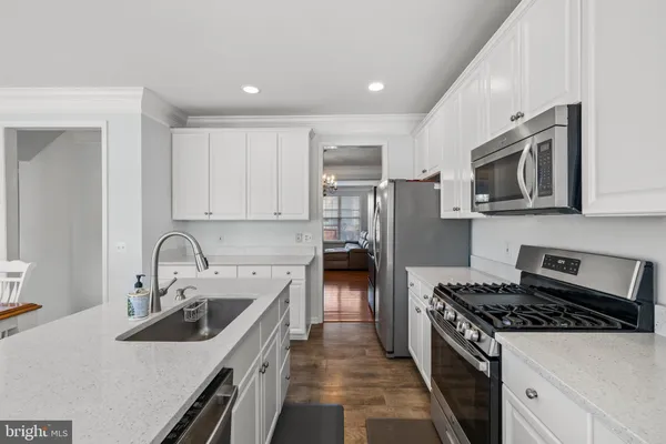 a kitchen with a sink stove and microwave