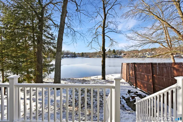 a view of a street with wooden stairs and fence