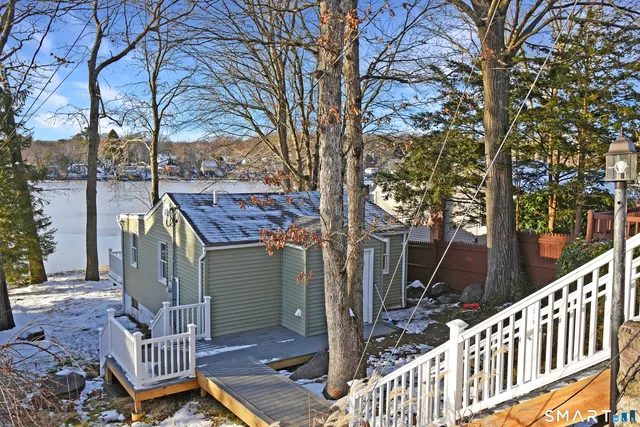 a view of a deck with wooden floor and fence