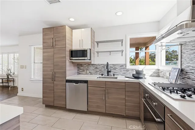 a kitchen with a sink stove and cabinets
