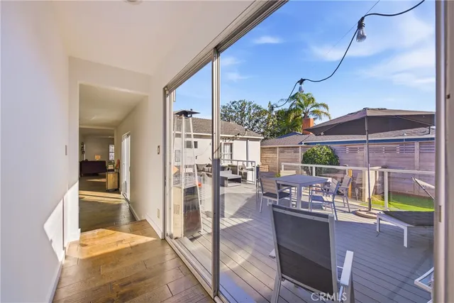 a dining room with furniture and a floor to ceiling window