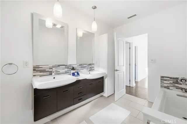 a spacious bathroom with a double vanity sink mirror and double