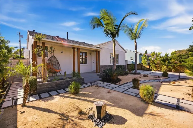 a view of a house with backyard porch and sitting area