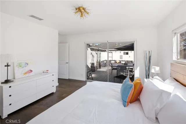 a bedroom with furniture and wooden floor
