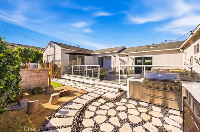 a view of a patio with table and chairs a barbeque
