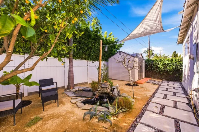 a backyard of a house with table and chairs