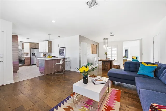a living room with furniture and kitchen view