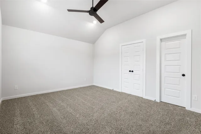 an empty room with fan and entrance