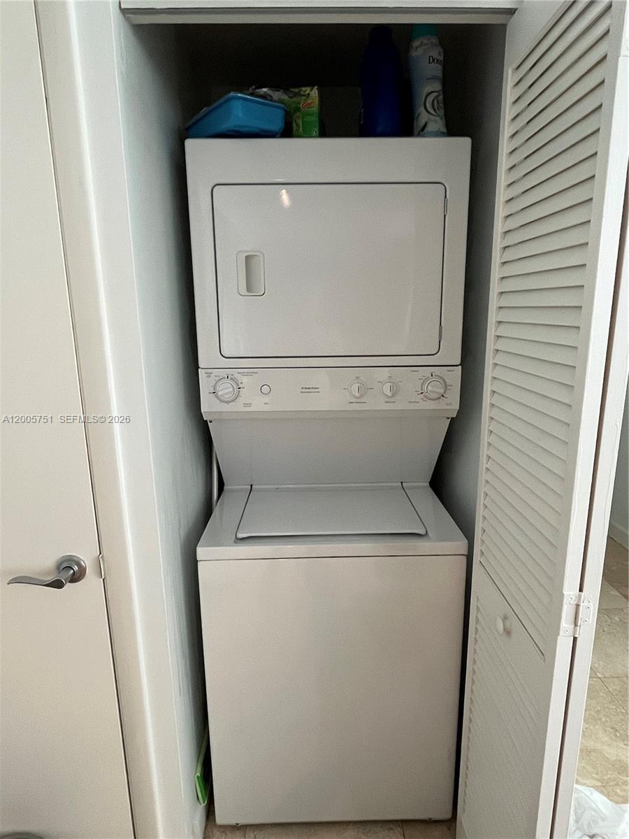 7275 Southwest 90th Street, Unit C408 Miami, FL 33156 - Photo 2 of 4 a utility room with dryer and washer