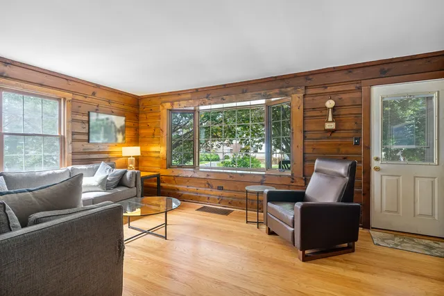 a living room with furniture and large windows