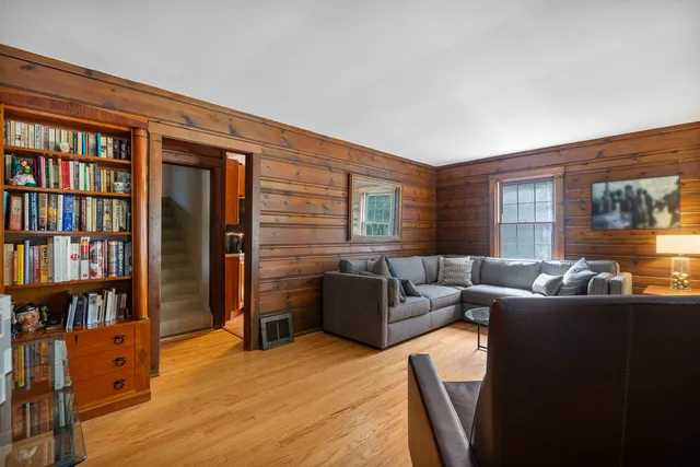 a living room with furniture and a bookshelf