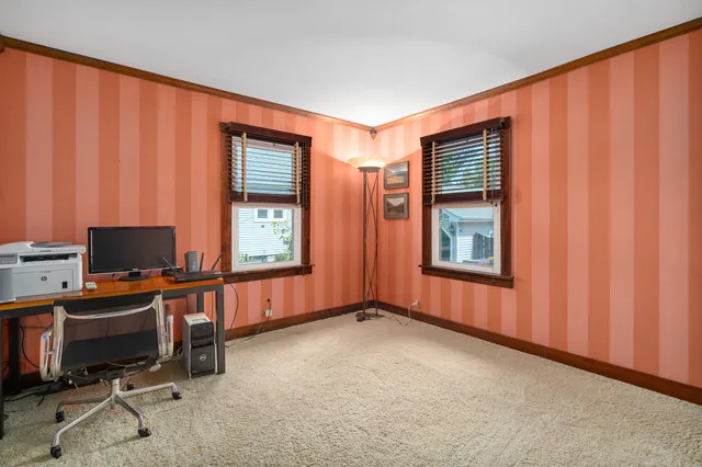a view of a workspace with furniture and a window