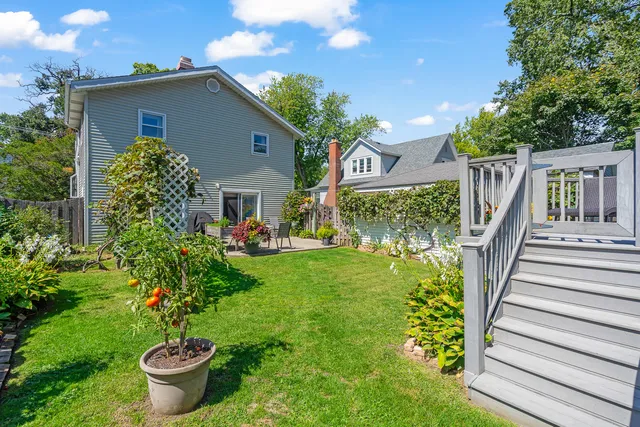 a front view of a house with a yard and fountain