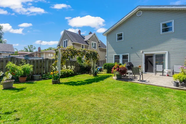 a view of a house with backyard porch and sitting area