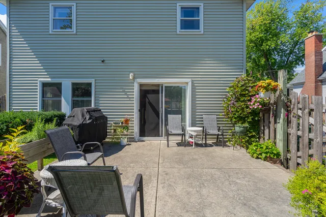 a view of backyard with outdoor seating and plants