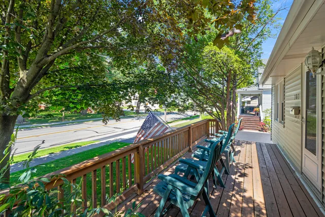 a view of a balcony with wooden floor and fence